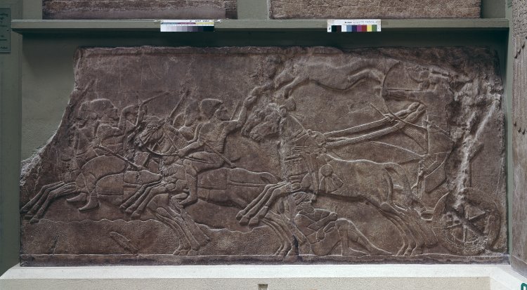 Gypsum wall panel relief showing an Assyrian official in a chariot pursuing enemy horsemen, 865 BC-860 BC, Neo-Assyrian (Iraq)