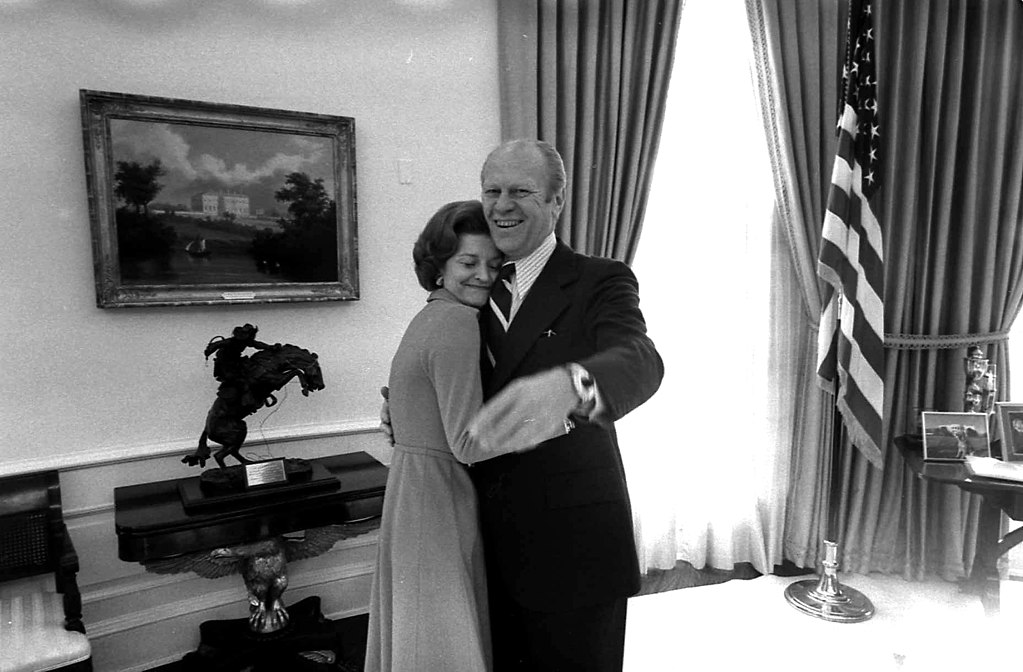 Photograph of President Gerald R. Ford and First Lady Betty Ford in the Oval Office with the Bronco Buster on the background, 6 December 1974