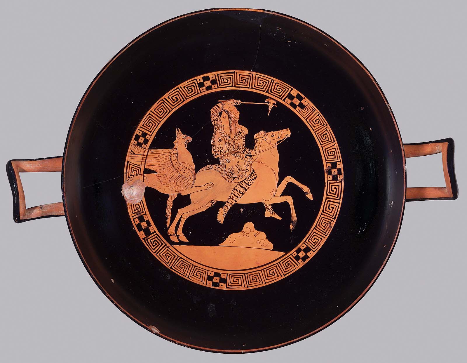 Drinking cup (kylix) with the depiction of an Arimaspean on horseback and a gryphon, cr. 4th century BC, Attica